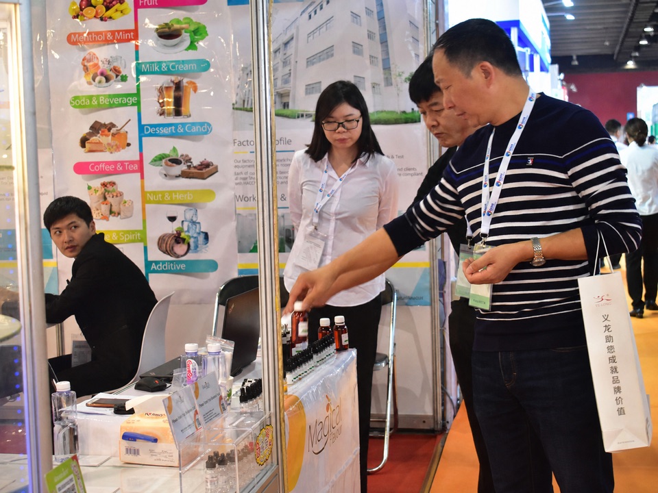 A visitor evaluating flavour samples at a Magical Flavour trade-show booth